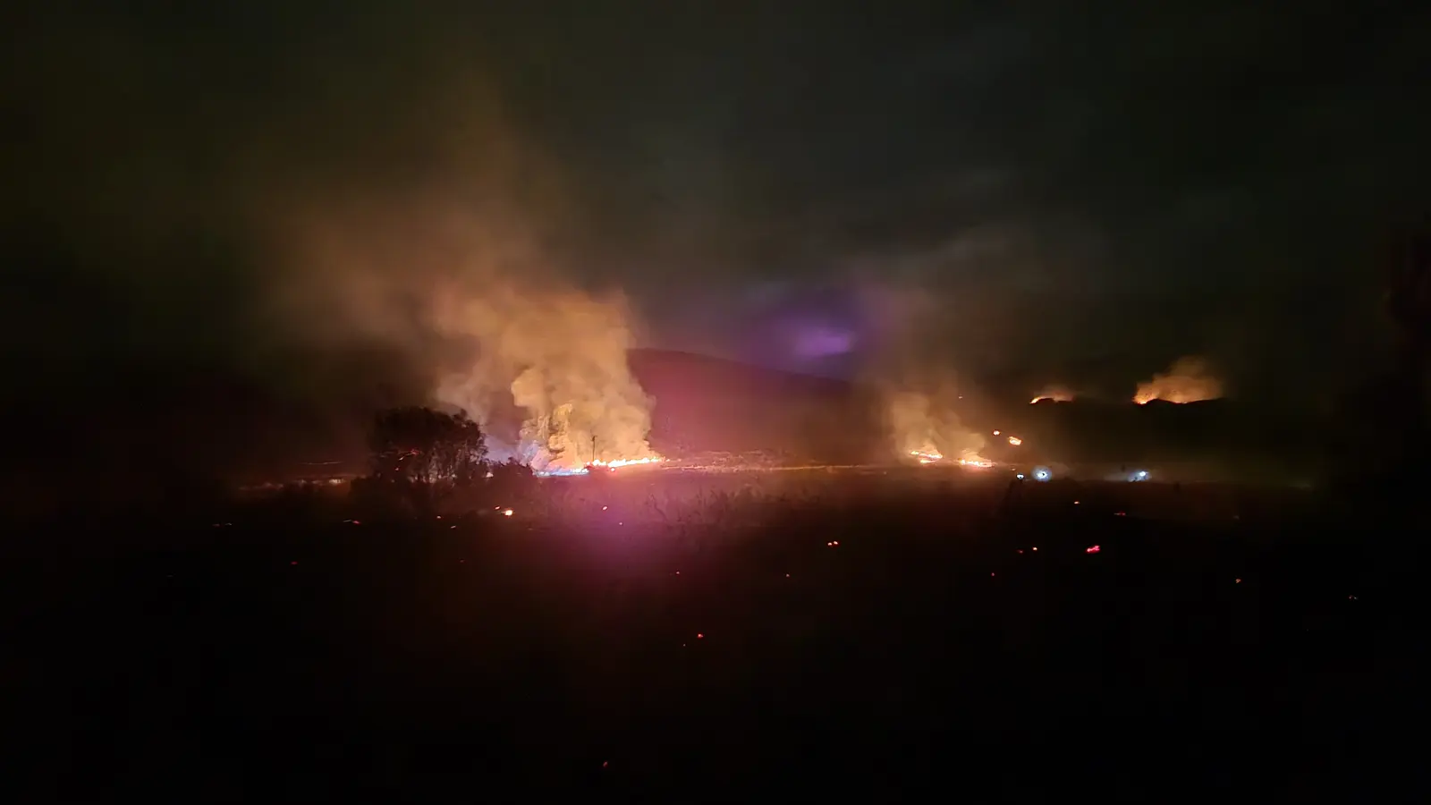 Active fire burning at night near Greyton