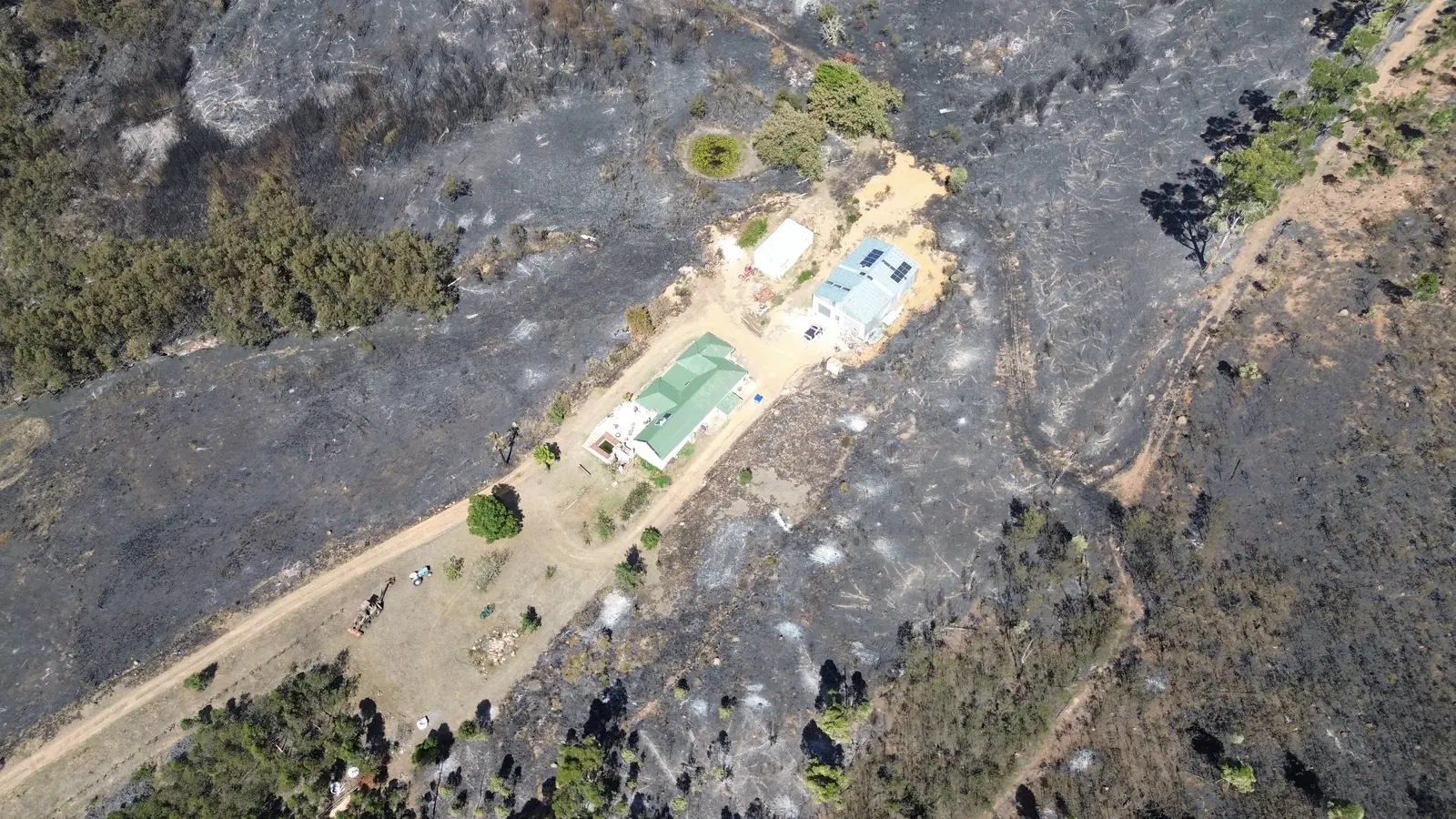Aerial view of fire aftermath around nearby properties